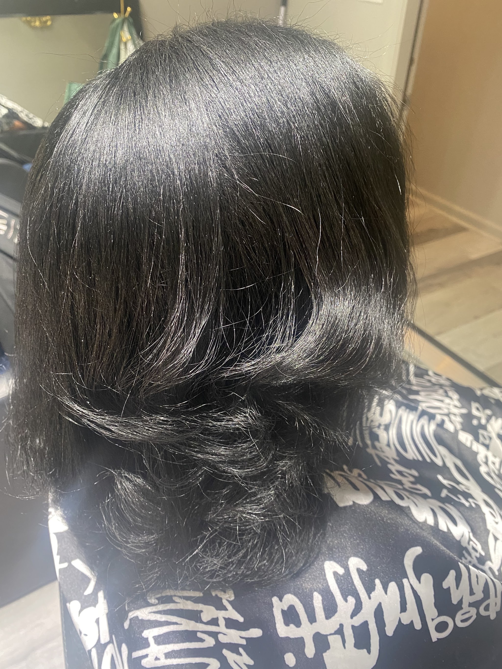 Glossy black bob with curled ends